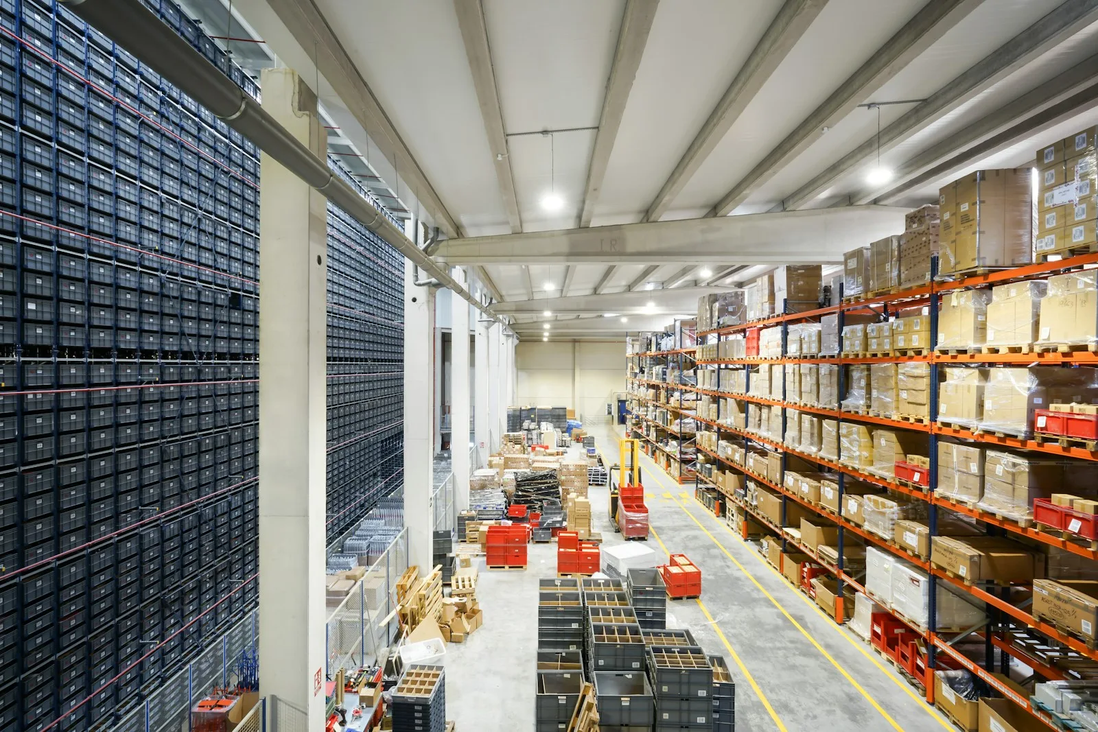 A large distribution warehouse full of palletized boxes, representing the catalog and fulfillment scale behind a B2B ecommerce portal