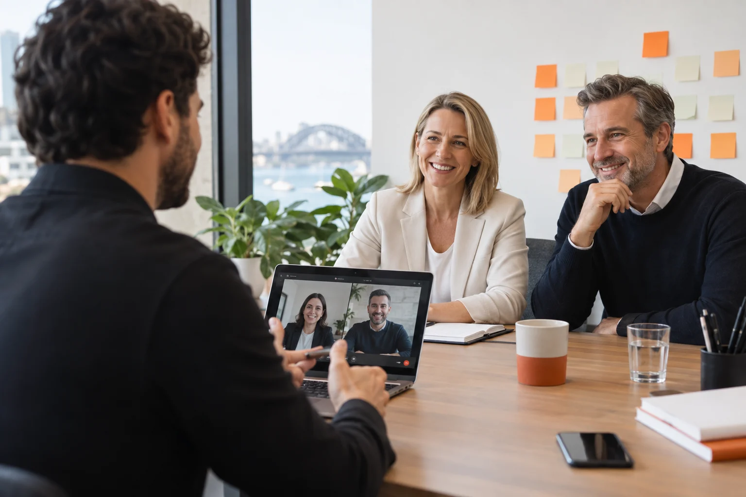 AI-generated photo showing A FactoryJet strategist on a video call with two partners of an Australian accounting firm, the laptop screen facing the strategist, sticky notes of service names on a wall behind the partners with no readable text
