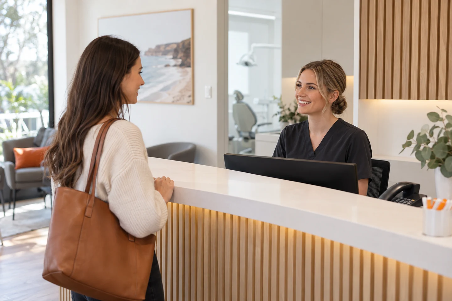 AI-generated photo showing A dental receptionist greeting an arriving patient face to face while the desk phone stays quiet
