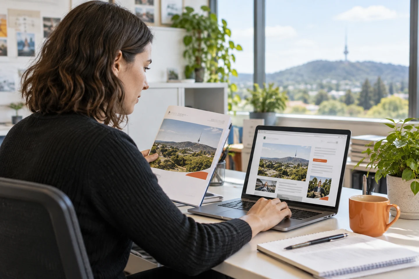 AI-generated photo showing A policy officer at a Braddon not-for-profit turning a printed annual report into a web page on her laptop