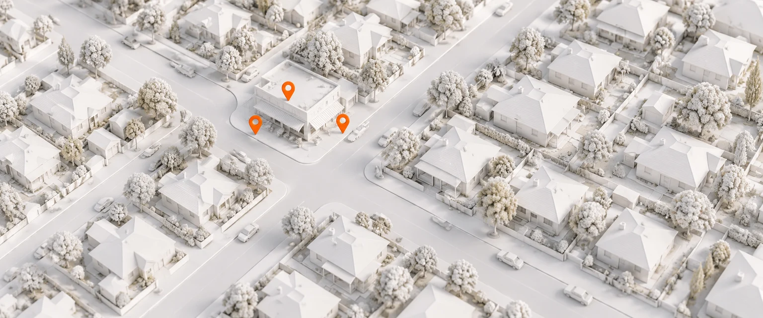AI-generated model: a white model of an Australian suburban street grid seen from above, three small orange map pins clustered near one corner shop, soft daylight, no text