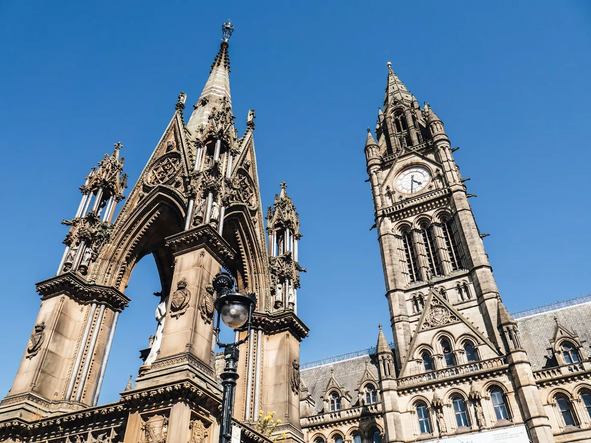 The Albert Memorial and the clock tower of Manchester Town Hall in Albert Square