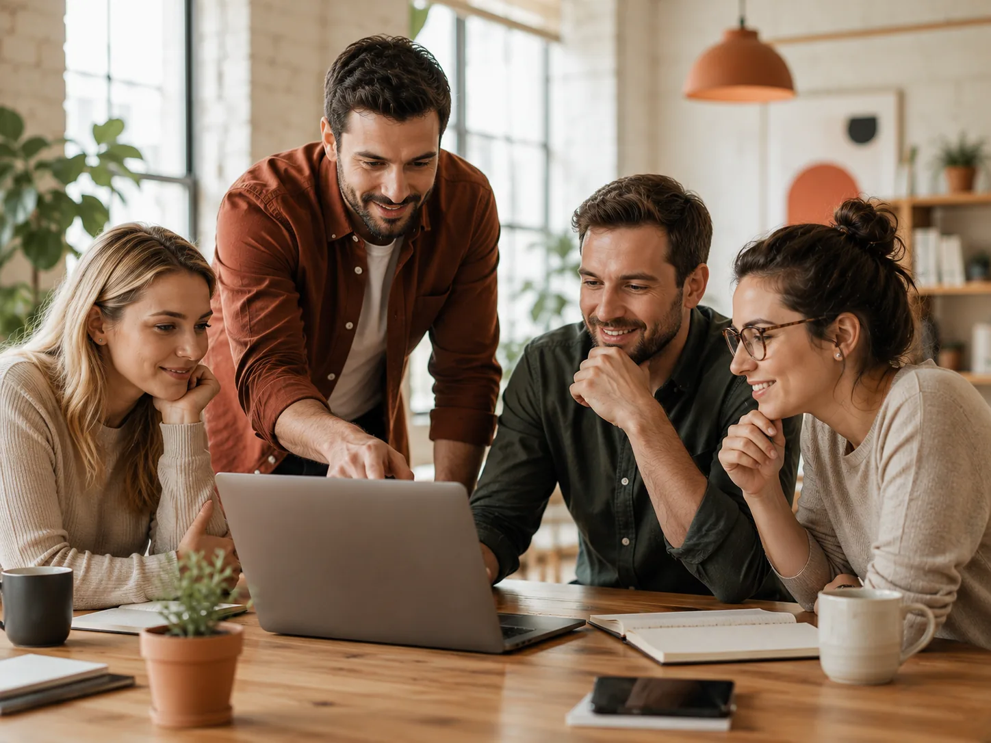 A small team reviewing an online storefront together around a laptop